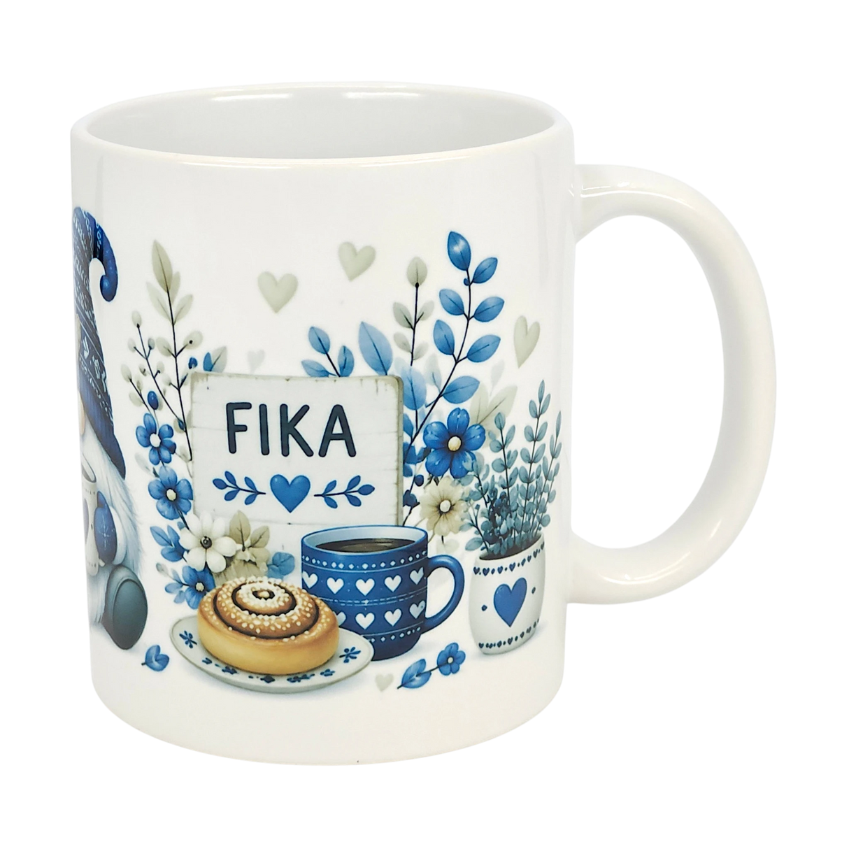 The Nordic Wholesale Mug: Blue Tomte Gnome Fika Ceramic Mug (11 oz) features blue and gray Scandinavian Tomte gnome designs with flowers, a cinnamon roll, coffee cup, and a “FIKA” sign surrounded by hearts and leaves.