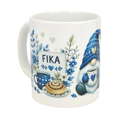 The Nordic Wholesale Mug: Blue Tomte Gnome Fika Ceramic Mug (11 oz) features a Scandinavian gnome in a knit hat with blue floral and heart accents, holding coffee and pastry near a FIKA sign.