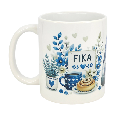 The Nordic Wholesale Mug: Blue Tomte Gnome Fika Ceramic Mug (11 oz) features a white Scandinavian gnome, blue flowers, coffee cup, cinnamon roll, and a "FIKA" sign with blue hearts.
