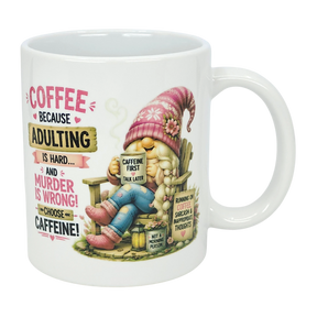 The Nordic Wholesale “Choose Caffeine Tomte” 11 oz ceramic mug features a Nordic gnome in a pink hat and boots, coffee in hand. The mug displays the text: “Coffee because adulting is hard… and murder is wrong! Choose caffeine!”.