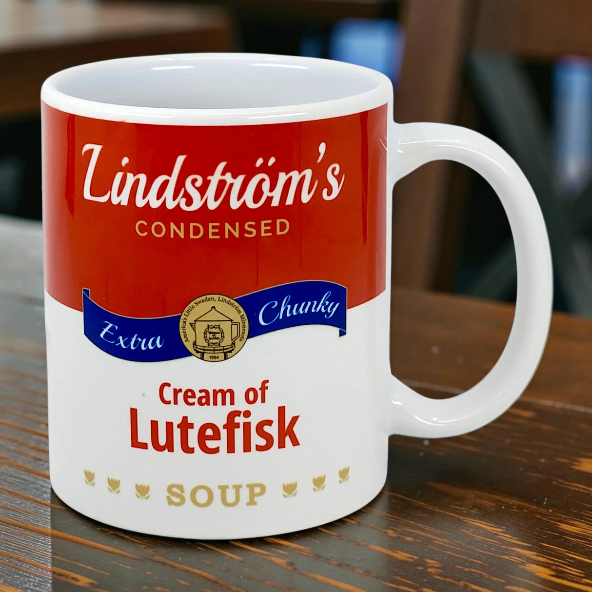 The 11oz Mug: Lindstrom's Condensed Extra Chunky Cream of Lutefisk Soup from Swedish Gift Store features a playful red and white label parody on white ceramic—an ideal Scandinavian heritage gift.