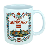 Celebrate Danish heritage with the Nordic Wholesale Mug: Denmark Nyhavn Ceramic Mug (11 oz Capacity), featuring vibrant floral patterns, “DENMARK” in bold red lettering, the Danish flag, a detailed illustration of the Little Mermaid statue, and a charming cityscape inspired by Nyhavn harbor—an ideal addition to your collection.