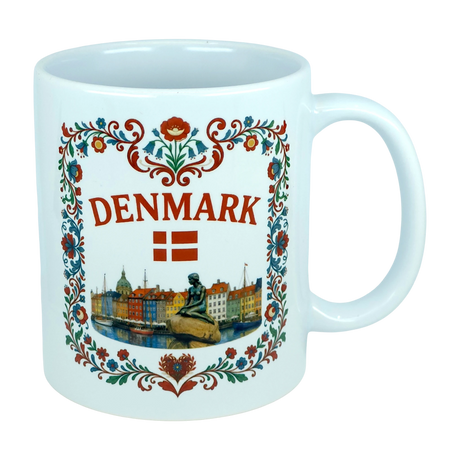 Celebrate Danish heritage with the Nordic Wholesale Mug: Denmark Nyhavn Ceramic Mug (11 oz Capacity), featuring vibrant floral patterns, “DENMARK” in bold red lettering, the Danish flag, a detailed illustration of the Little Mermaid statue, and a charming cityscape inspired by Nyhavn harbor—an ideal addition to your collection.