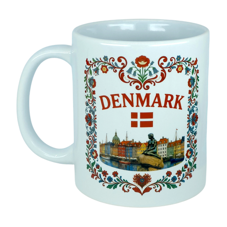 The Nordic Wholesale Mug: Denmark Nyhavn Ceramic Mug (11 oz Capacity) is a white Danish heritage mug showcasing DENMARK, a red Danish flag, floral accents, and detailed illustrations of Copenhagen’s vibrant Nyhavn harbor along with the iconic Little Mermaid statue.
