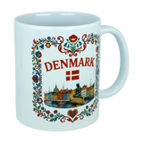 The Mug: Denmark Nyhavn Ceramic Mug (11 oz Capacity) by Nordic Wholesale is a white ceramic mug featuring colorful floral designs, the word "DENMARK," the Danish flag, and delightful illustrations of famous Danish landmarks such as Nyhavn harbor and the iconic Little Mermaid statue.