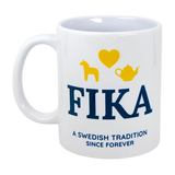 The Nordic Wholesale Mug: Fika — A Swedish Tradition Since Forever Ceramic Mug (11 oz) features blue "FIKA" text and the phrase "A Swedish tradition since forever." Above, cheerful yellow icons—a horse, a heart, and a teapot—capture the spirit of Scandinavian coffee culture. This charming mug is perfect for celebrating the beloved ritual of fika.