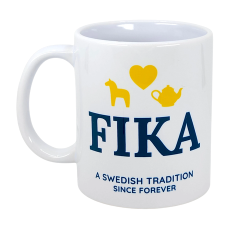 The Nordic Wholesale Mug: Fika — A Swedish Tradition Since Forever Ceramic Mug (11 oz) features blue "FIKA" text and the phrase "A Swedish tradition since forever." Above, cheerful yellow icons—a horse, a heart, and a teapot—capture the spirit of Scandinavian coffee culture. This charming mug is perfect for celebrating the beloved ritual of fika.