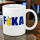 The Swedish Gift Store’s 11 oz ceramic mug features “FIKA” in bold blue, with three stacked yellow cups for the “I,” echoing the Swedish flag and classic Fika charm.
