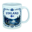 The Nordic Wholesale Mug: Finland Lakeside Cabin Ceramic Mug (11 oz Capacity) is a white Finnish ceramic mug decorated with the Finnish flag and an illustration of a Nordic lakeside cabin nestled among trees, all bordered by an elegant blue floral design—making it an ideal gift to celebrate Finnish heritage.