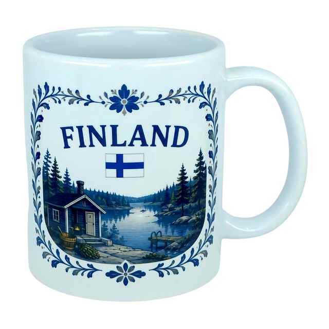 The Nordic Wholesale Mug: Finland Lakeside Cabin Ceramic Mug (11 oz Capacity) is a white Finnish ceramic mug decorated with the Finnish flag and an illustration of a Nordic lakeside cabin nestled among trees, all bordered by an elegant blue floral design—making it an ideal gift to celebrate Finnish heritage.