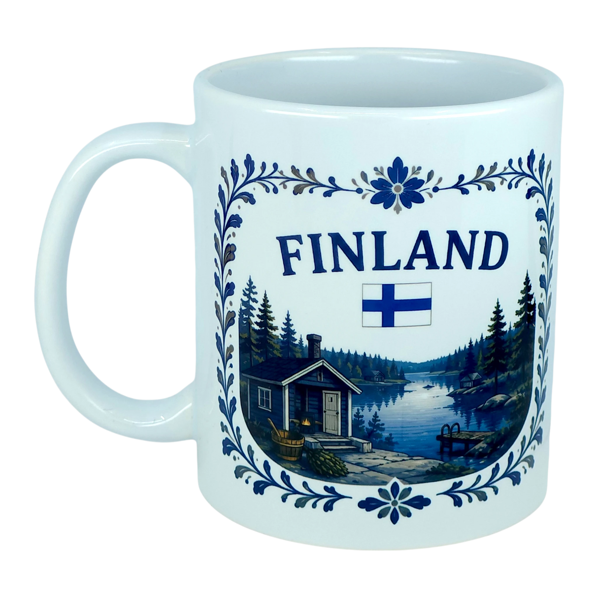 Discover the Nordic Wholesale Mug: Finland Lakeside Cabin Ceramic Mug (11 oz Capacity), featuring the word "Finland," the Finnish flag, and a scenic illustration of a Nordic lakeside cabin surrounded by trees, bordered with blue floral designs—a perfect Finnish heritage gift.