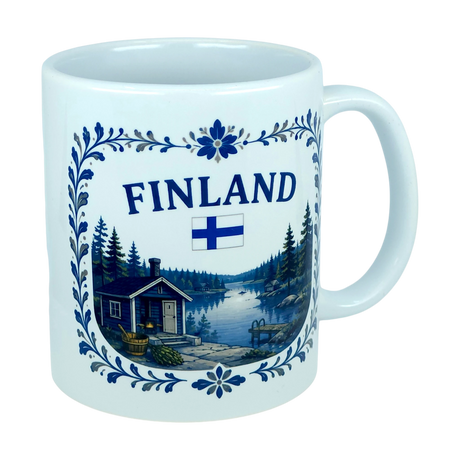 Introducing the Mug: Finland Lakeside Cabin Ceramic Mug (11 oz Capacity) by Nordic Wholesale—a white Finnish ceramic mug adorned with a scenic illustration of a Nordic lakeside cabin surrounded by trees, featuring a Finnish flag and decorative blue floral patterns. This mug makes an ideal gift for celebrating Finnish heritage.