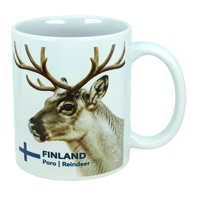 Discover the Nordic Wholesale Mug: Finland National Animal Reindeer Ceramic Mug (11 oz Capacity)—a white ceramic mug adorned with a delightful reindeer and antlers illustration. The text "FINLAND Poro | Reindeer" is displayed beside a blue cross, reminiscent of the Finnish flag. This charming mug is perfect for savoring your favorite drinks and adds a cozy touch of Lapland to any coffee break, making it an essential piece for fans of Scandinavian design and lovers of Finnish culture.