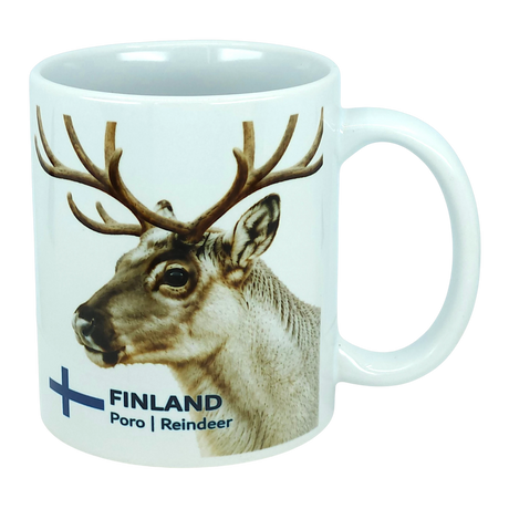 Discover the Nordic Wholesale Mug: Finland National Animal Reindeer Ceramic Mug (11 oz Capacity)—a white ceramic mug adorned with a delightful reindeer and antlers illustration. The text "FINLAND Poro | Reindeer" is displayed beside a blue cross, reminiscent of the Finnish flag. This charming mug is perfect for savoring your favorite drinks and adds a cozy touch of Lapland to any coffee break, making it an essential piece for fans of Scandinavian design and lovers of Finnish culture.