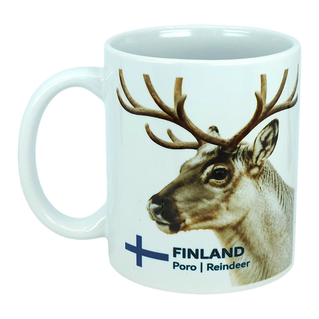 The Mug: Finland National Animal Reindeer Ceramic Mug (11 oz Capacity) by Nordic Wholesale is a white ceramic mug showcasing a reindeer head illustration alongside the text "FINLAND Poro | Reindeer" and a blue Finnish flag cross. This stylish mug is ideal for savoring your favorite hot beverages and adds a touch of Lapland charm to any coffee break.