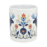 The Nordic Wholesale Folk Art Moose Ceramic Mug (11 oz) features a white base with Scandinavian folk art, two blue moose, red and blue flowers, leafy branches, and a charming heart motif.
