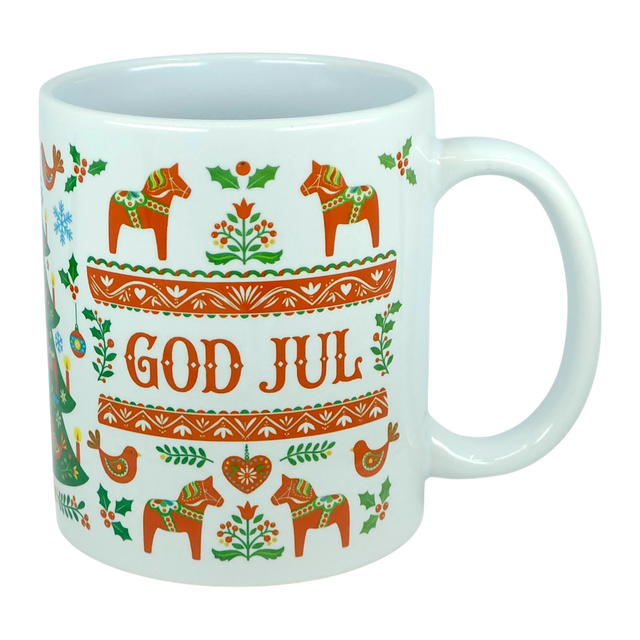 The Nordic Wholesale Mug: God Jul Dala Horse Christmas Ceramic Mug (11 oz Capacity) features Scandinavian folk art designs with red horses, hearts, and flowers. This charming mug displays the words "GOD JUL" in bold red letters at the center, surrounded by festive Nordic patterns.