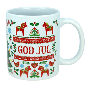 Celebrate Scandinavian traditions with the God Jul Dala Horse Christmas Ceramic Mug (11 oz Capacity) from Nordic Wholesale. This white ceramic mug features vibrant red and green Nordic folk art patterns, showcasing Dala horses, birds, trees, and "GOD JUL" in the center. It's the perfect coffee cup to add a festive touch to your holiday mornings or gift to lovers of charming Scandinavian decor.