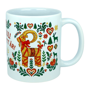This white 11 oz ceramic mug from Nordic Wholesale features the God Jul Gott Nytt År Yule Goat design, beautifully decorated with colorful Scandinavian folk art motifs including hearts, trees, flowers, and animals in vibrant red, green, and yellow. Charming Nordic details and partially visible Swedish text complement this festive holiday mug.