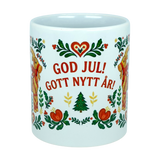 The Nordic Wholesale Mug: God Jul Gott Nytt År Yule Goat Christmas Ceramic Mug (11 oz Capacity) features cheerful Scandinavian-style floral accents and the festive greeting “God Jul! Gott Nytt År!” above a charming tree, meaning “Merry Christmas! Happy New Year!” in Swedish. This delightful Nordic folk art mug is perfect for bringing holiday spirit to your morning coffee.