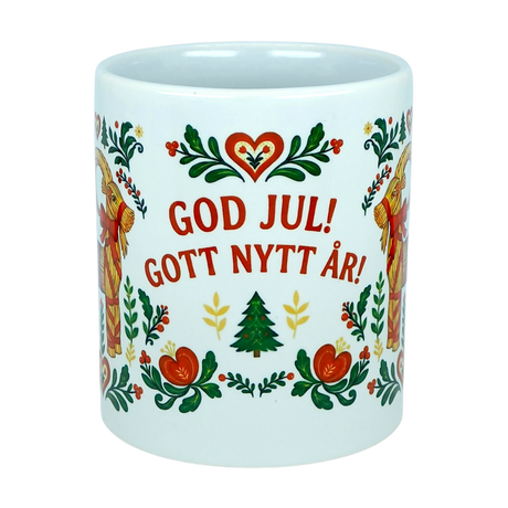The Nordic Wholesale Mug: God Jul Gott Nytt År Yule Goat Christmas Ceramic Mug (11 oz Capacity) features cheerful Scandinavian-style floral accents and the festive greeting “God Jul! Gott Nytt År!” above a charming tree, meaning “Merry Christmas! Happy New Year!” in Swedish. This delightful Nordic folk art mug is perfect for bringing holiday spirit to your morning coffee.