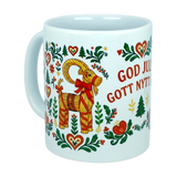 The Mug: God Jul Gott Nytt År Yule Goat Christmas Ceramic Mug (11 oz Capacity) from Nordic Wholesale is a white ceramic mug adorned with a straw Yule Goat, hearts, flowers, trees, and the Swedish greeting “God Jul & Gott Nytt År” in festive red. This charming Scandinavian holiday mug showcases traditional Nordic folk art designs—perfect from Nordic Wholesale for enjoying your favorite warm winter beverages.