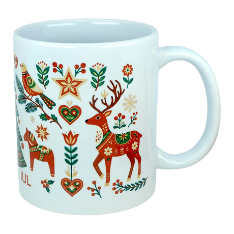 Experience festive Nordic tradition with the Mug: God Jul Nordic Folk Art Ceramic Mug (11 oz Capacity) by Nordic Wholesale, featuring a white Scandinavian design adorned with colorful folk art holiday motifs—reindeer, horses, birds, stars, hearts, and an array of flowers and branches in vibrant red, green, gold, and orange hues—a cheerful celebration of classic Scandinavian-style mug decor.