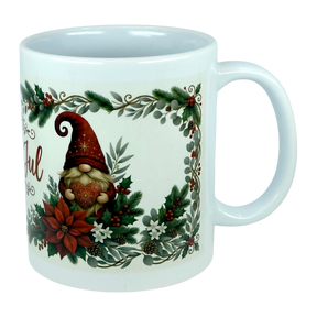 Celebrate the season with the Mug: God Jul Tomte Nordic Christmas Ceramic Mug (11 oz Capacity) from Nordic Wholesale. This white ceramic mug features a festive gnome holding a heart, surrounded by poinsettias, pinecones, holly, and greenery within a holiday-themed border. A charming Scandinavian design that brings a touch of Nordic cheer to your festivities.