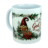 Introducing the God Jul Tomte Nordic Christmas Ceramic Mug by Nordic Wholesale—a white 11 oz mug featuring a festive Scandinavian design. The mug showcases a cheerful gnome in a red hat holding a heart, surrounded by vibrant poinsettias, holly, and greenery. The cozy holiday spirit is captured perfectly, with part of the “God Jul” text visible on the right side.