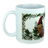 The God Jul Tomte Nordic Christmas Ceramic Mug by Nordic Wholesale features a festive Scandinavian design with a gnome in a red hat, surrounded by greenery, pinecones, berries, and white flowers within a decorative border.