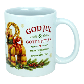 Introducing the Mug: God Jul Yule Goat Ceramic Mug (11 oz Capacity) by Nordic Wholesale—a white ceramic mug adorned with a charming Swedish Yule Goat, pine, and berries. Featuring festive text in red and green that reads: "GOD JUL & GOTT NYTT ÅR, Merry Christmas & Happy New Year," this Scandinavian Christmas mug is perfect for adding a touch of Nordic tradition to your holiday celebrations.