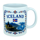 Introducing the Mug: Iceland Church Mountain Ceramic Mug (11 oz Capacity) by Nordic Wholesale. This white ceramic mug features "ICELAND," the Icelandic flag, and a picturesque scene of mountains, a church, water, and icebergs. A decorative blue and red floral border frames the Nordic landscape, making this mug an ideal gift for anyone celebrating their Icelandic heritage.