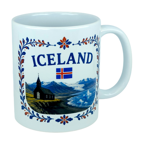 Celebrate Icelandic heritage with the Nordic Wholesale Mug: Iceland Church Mountain Ceramic Mug (11 oz Capacity). This white mug features the “ICELAND” text, the Icelandic flag, and a scenic illustration of mountains, a black church, and water framed by a floral border—a perfect gift that beautifully captures the Nordic landscape.