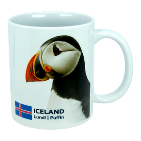 This 11 oz ceramic coffee mug from Nordic Wholesale, the "Mug: Iceland National Animal Puffin," features a photo of an Icelandic puffin alongside the Icelandic flag, with "ICELAND Lundi | Puffin" printed below the image—making it the perfect Nordic wildlife mug for nature lovers.