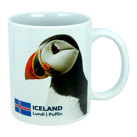 This 11 oz ceramic coffee mug from Nordic Wholesale, the "Mug: Iceland National Animal Puffin," features a photo of an Icelandic puffin alongside the Icelandic flag, with "ICELAND Lundi | Puffin" printed below the image—making it the perfect Nordic wildlife mug for nature lovers.