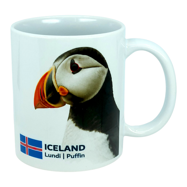 This 11 oz ceramic coffee mug from Nordic Wholesale, the "Mug: Iceland National Animal Puffin," features a photo of an Icelandic puffin alongside the Icelandic flag, with "ICELAND Lundi | Puffin" printed below the image—making it the perfect Nordic wildlife mug for nature lovers.