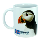 The Mug: Iceland National Animal Puffin Ceramic Coffee Mug (11 oz Capacity) by Nordic Wholesale features a charming puffin illustration, the Icelandic flag, and the text “ICELAND Lundi | Puffin.” This white ceramic mug is a perfect tribute to Nordic wildlife, celebrating Iceland’s iconic national bird.