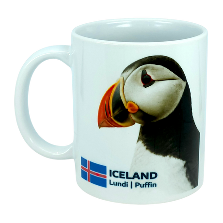 The Mug: Iceland National Animal Puffin Ceramic Coffee Mug (11 oz Capacity) by Nordic Wholesale features a charming puffin illustration, the Icelandic flag, and the text “ICELAND Lundi | Puffin.” This white ceramic mug is a perfect tribute to Nordic wildlife, celebrating Iceland’s iconic national bird.
