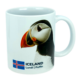 Introducing the Mug: Iceland National Animal Puffin Ceramic Coffee Mug (11 oz Capacity) by Nordic Wholesale—a white ceramic mug decorated with an image of the iconic Icelandic puffin, the national flag of Iceland, and the words ICELAND Lundi | Puffin. This charming Nordic wildlife mug is perfect for nature enthusiasts and lovers of all things Icelandic.