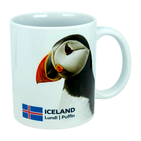Introducing the Mug: Iceland National Animal Puffin Ceramic Coffee Mug (11 oz Capacity) by Nordic Wholesale—a white ceramic mug decorated with an image of the iconic Icelandic puffin, the national flag of Iceland, and the words ICELAND Lundi | Puffin. This charming Nordic wildlife mug is perfect for nature enthusiasts and lovers of all things Icelandic.