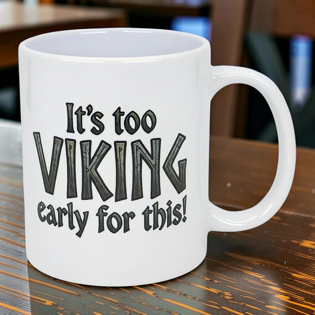The Swedish Gift Store’s 11 oz white ceramic mug features “It’s Too Viking Early For This” in bold black text, displayed on a wooden table.