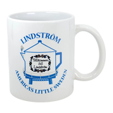 The Swedish Gift Store's 11 oz ceramic mug features Lindstrom’s iconic blue coffee pot water tower and “America’s Little Sweden” text—a perfect Chisago Lakes souvenir.