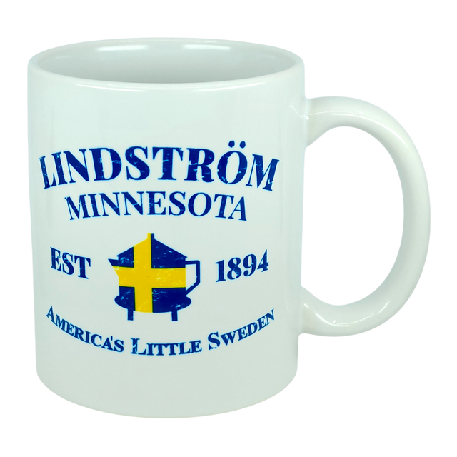 This 11 oz white ceramic mug from Nordic Wholesale features blue text that reads "Lindstrom Minnesota EST 1894 America’s Little Sweden," along with a yellow and blue Swedish flag shaped like the state of Minnesota. The perfect mug for anyone proud of their Lindstrom roots and Swedish heritage. Product name: Mug: Lindstrom Minnesota America's Little Sweden Ceramic Mug (11 oz Capacity).