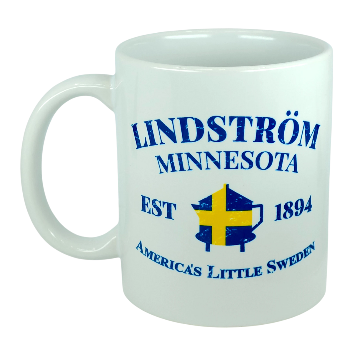 Celebrate Lindstrom’s rich heritage with the Nordic Wholesale Mug: Lindstrom Minnesota America's Little Sweden Ceramic Mug (11 oz Capacity), featuring blue text—“Lindström Minnesota EST 1894 America’s Little Sweden”—and an illustration of a Swedish flag over a coffee pot, perfect for anyone proud of their Swedish roots.