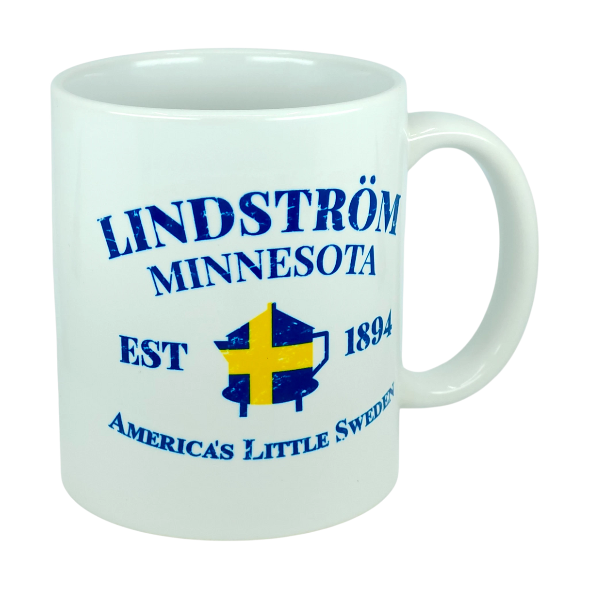 Show off your heritage with the Nordic Wholesale Mug: Lindstrom Minnesota America's Little Sweden Ceramic Mug (11 oz Capacity), featuring blue text, a yellow and blue Swedish flag in the center, and a classic white ceramic finish—ideal for anyone looking for a unique Swedish heritage mug.
