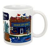 The Mug: Lindstrom, MN — America's Little Sweden 11oz ceramic souvenir mug by Swedish Gift Store features colorful illustrations of iconic Lindstrom landmarks, including flags, boats on a lake, birds, and a statue.