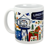 The 11oz ceramic “Lindstrom, MN — America’s Little Sweden” mug by Swedish Gift Store showcases vibrant Scandinavian folk art with a horse, trees, birds, and the town’s water tower reading “Välkommen till Lindström.”.