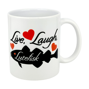 The Mug: Live, Laugh, Lutefisk | 11oz Ceramic Mug by Nordic Wholesale features a black script phrase, three red hearts, and a black fish silhouette—an ideal Scandinavian humor mug or lutefisk gift with Nordic charm.
