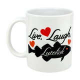 The Nordic Wholesale 11oz ceramic mug features “Live, Laugh, Lutefisk” in black text, a black fish graphic, and red hearts—a fun Scandinavian humor gift for fans of quirky traditions.