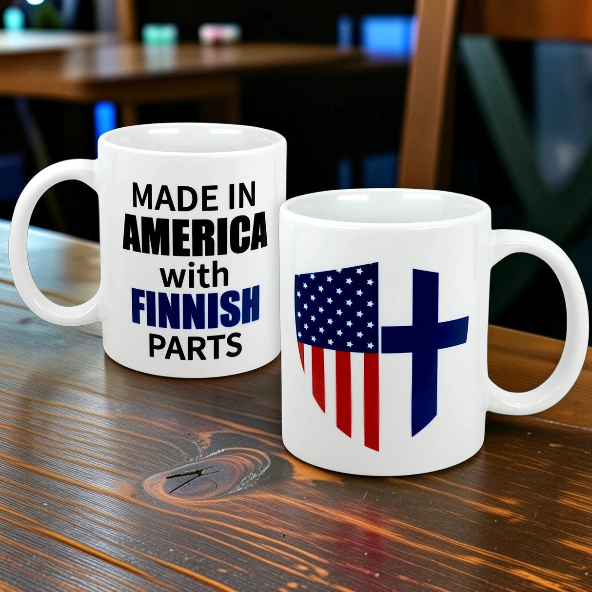 Two white 11 oz ceramic mugs from Swedish Gift Store sit on a wooden table; one says "Made in America with Finnish Parts," the other shows an American flag and blue Nordic cross—ideal for celebrating your Finnish-American heritage.